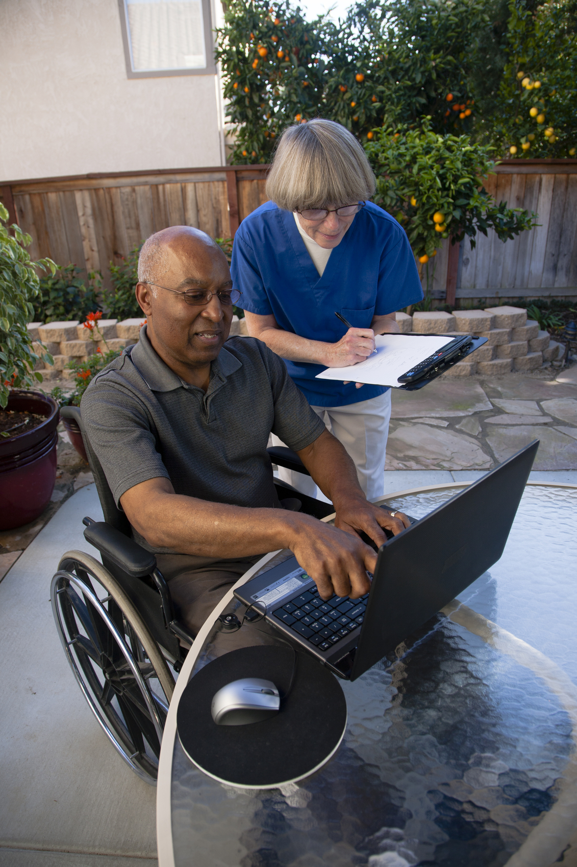 Healthcare-worker-helping-disabled-senior-with-computer