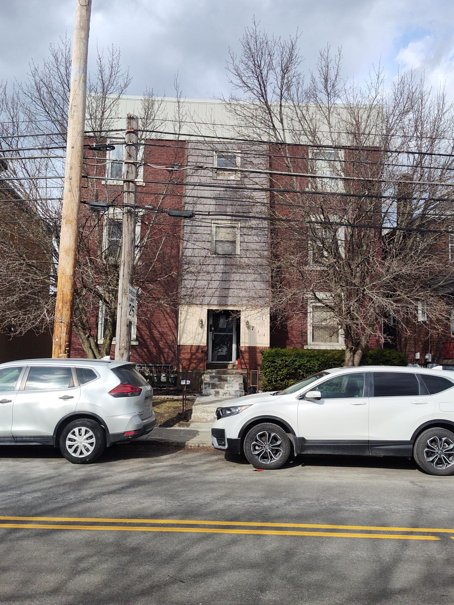 Three-story apartment building viewed from the street